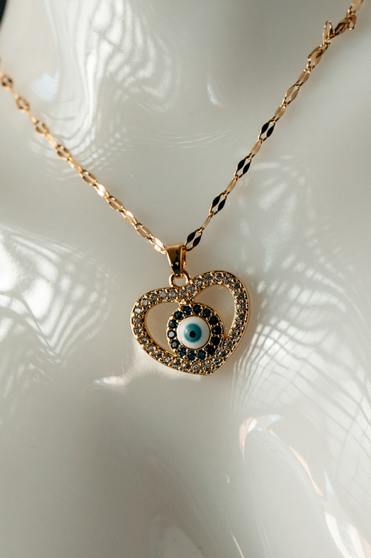 Heart-Shaped Evil Eye Necklace – Gold-Plated Protection Pendant with Blue & White Crystal Charm.