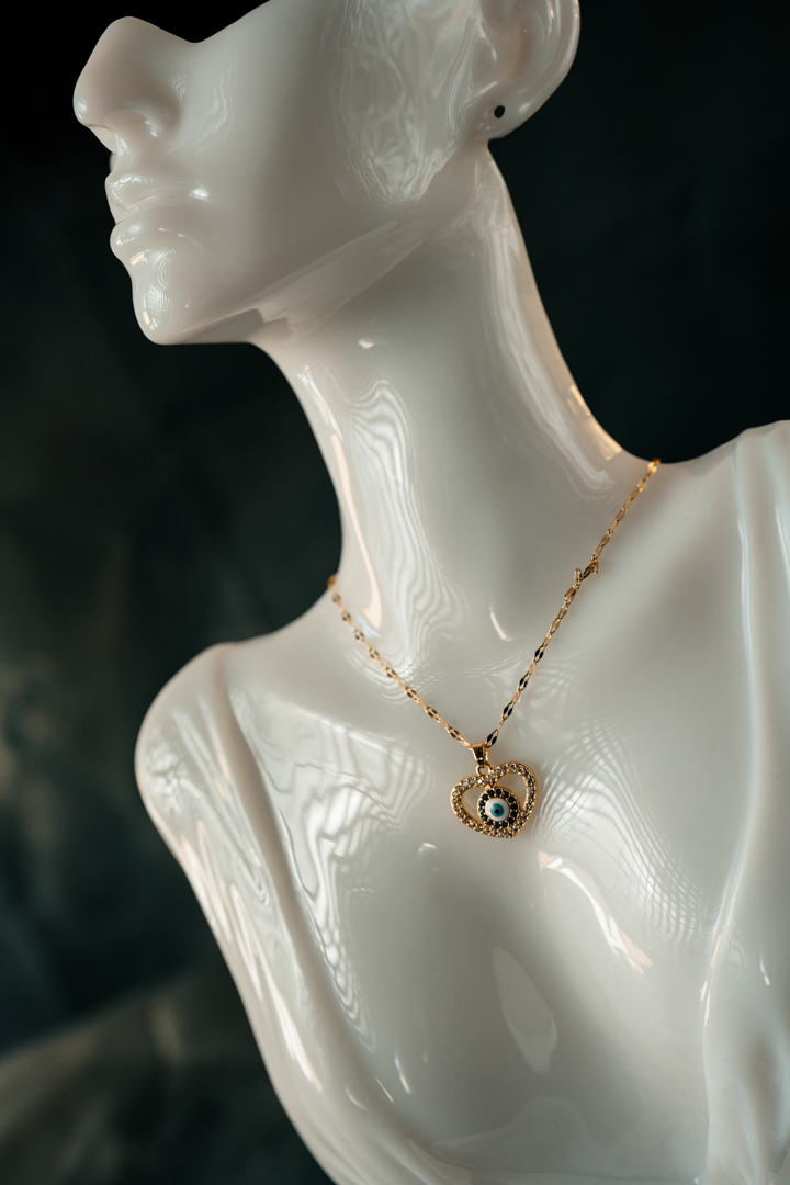 Heart-Shaped Evil Eye Necklace – Gold-Plated Protection Pendant with Blue & White Crystal Charm.